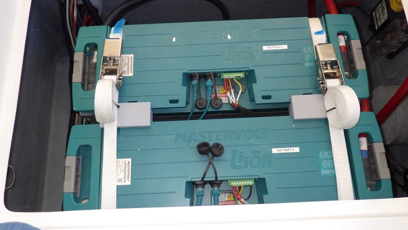 Mastervolt marine batteries secured in a battery compartment.