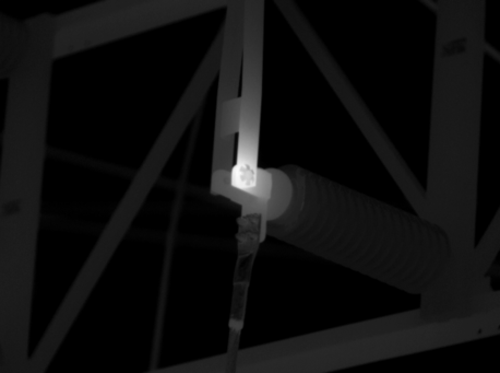 Grayscale thermal image showing contrasting temperatures along a structural connection.